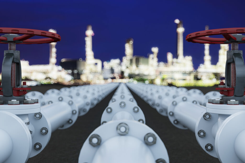 Industrial Oil And Gas Pipeline With Valves At Night Refinery